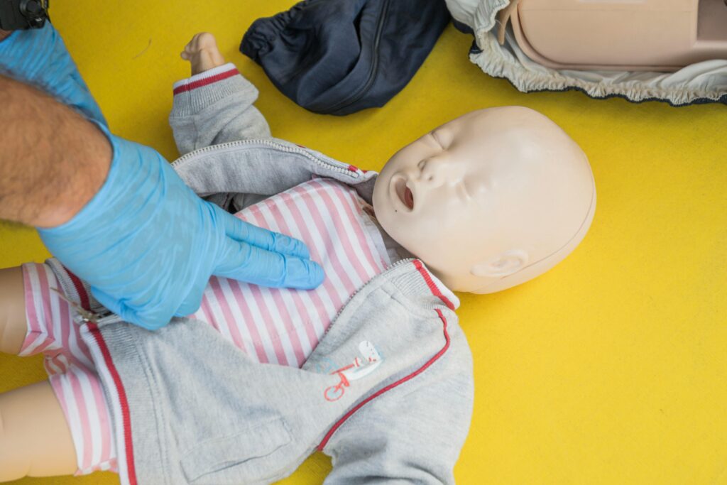 pexels photo 28271070 28271070 A person demonstrates infant CPR on a manikin, highlighting first aid techniques.