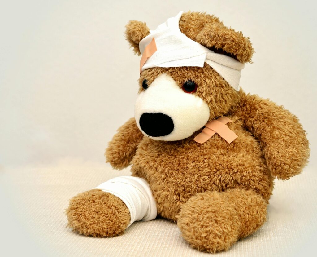 teddy teddy bear association ill 42230 42230 A brown teddy bear with bandages, depicting a playful take on injury recovery in a minimalist setting.
